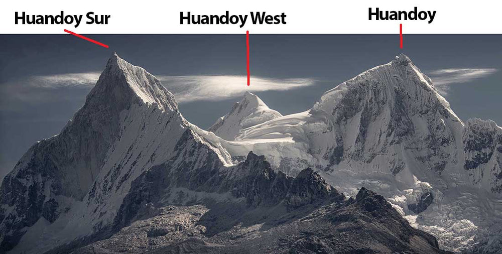 A panorama showing the snow covered peaks of Huandoy Sur, Huandoy West and Huandoy in the cordillera blanca, Peru. Lenticular clouds stream between the three peaks.