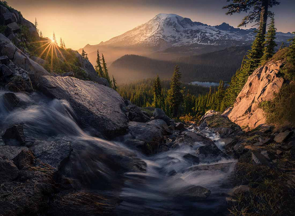 Oregon sunrise with a mountain waterfall and snow covered mountain scene. The orton effect done well.