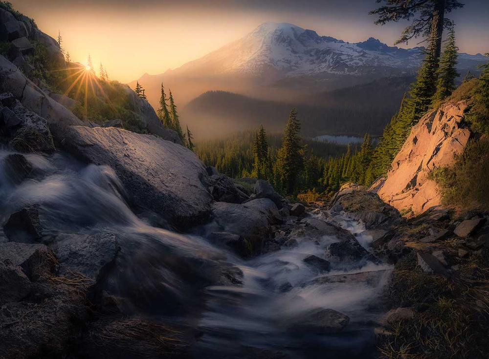 Oregon sunrise with a mountain waterfall and snow covered mountain scene. The orton effect over-used.