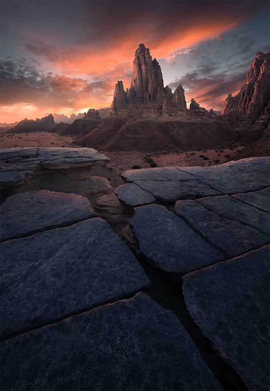 Wadi Al Disah mountain in Saudi Arabia with rock patterns and pink sunset.