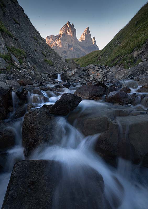 aiguilles d'arves mountain with the waterfall creating a leading line to the stony peaks beyond.