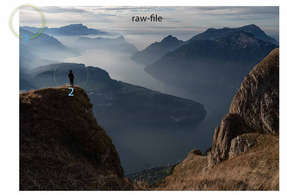 a raw-file shows incorrect balance in a mountain scene with a person standing on the edge of a cliff.