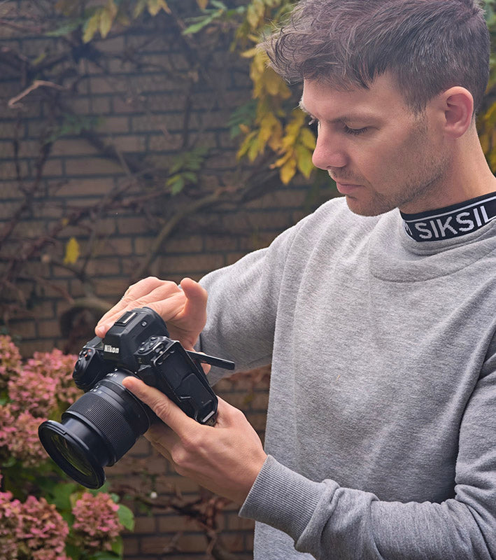 Handsome Max Rive reviews photos on his Nikon Z8 camera in the field.