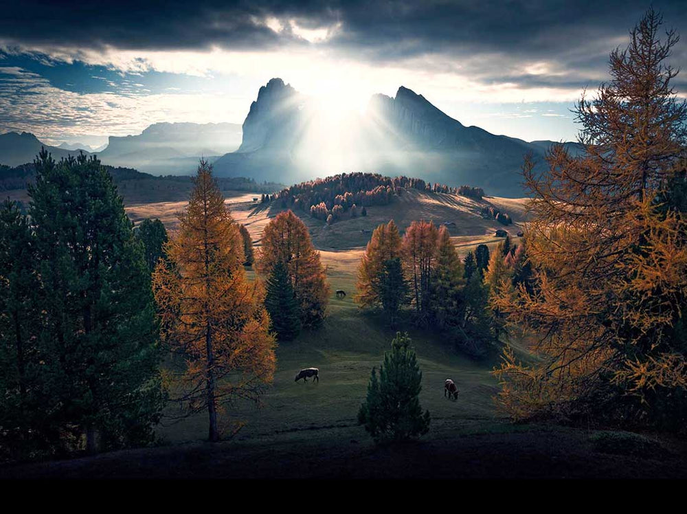 over-exposed sky peeking through clouds in dolomites autumn image of alpe di siusi.
