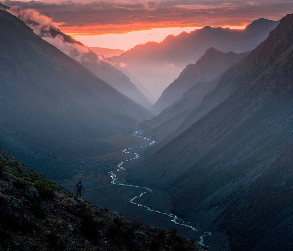 a large valley mountain scene with a winding river below and red sky illustrates lack of depth.