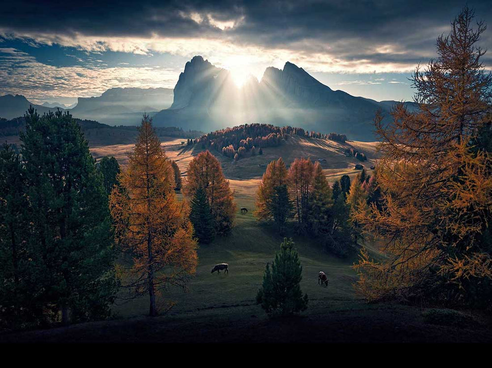 correctly exposed sky peeking through clouds in dolomites autumn image of alpe di siusi.