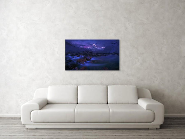 Ama Dablam metal print hanged on living room wall with chair - mountain landscape with river