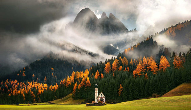 Dolomites Autumn Canvas Print orange colored autumn forest, with church on foreground and cloudy mountain 