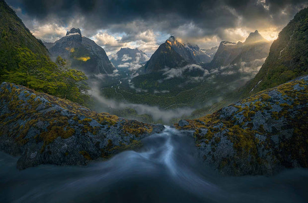 Milford Sound panorama with dramatic weather and small stream on the foreground