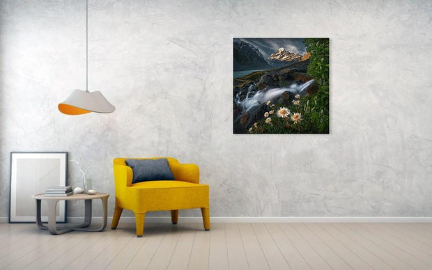 Mount Cook Print hanged in living room wall displaying flowers and a waterfall in summer
