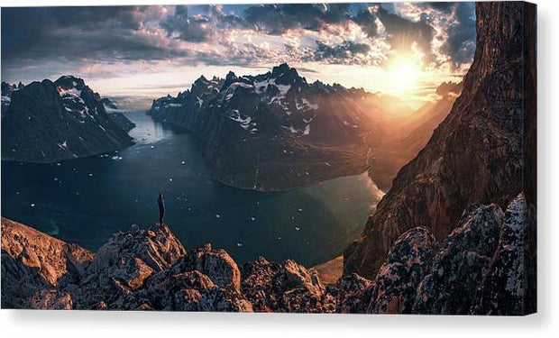 canvas print mockup with mirrored sides of Person looking towards the setting sun in Greenalnd with an ice-filled fjord down below 