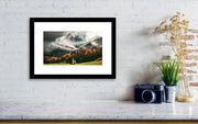 A framed print of the St Johann Church in the Italian dolomites during cloudy weather and autumn colors- small size hanged