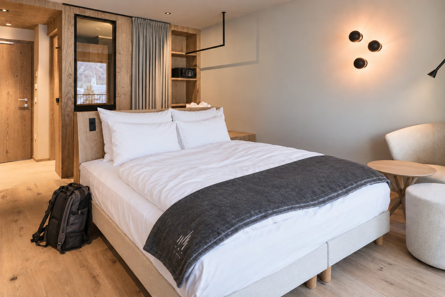 An inviting, unoccupied bed in a warm wooden room at AMA Stay